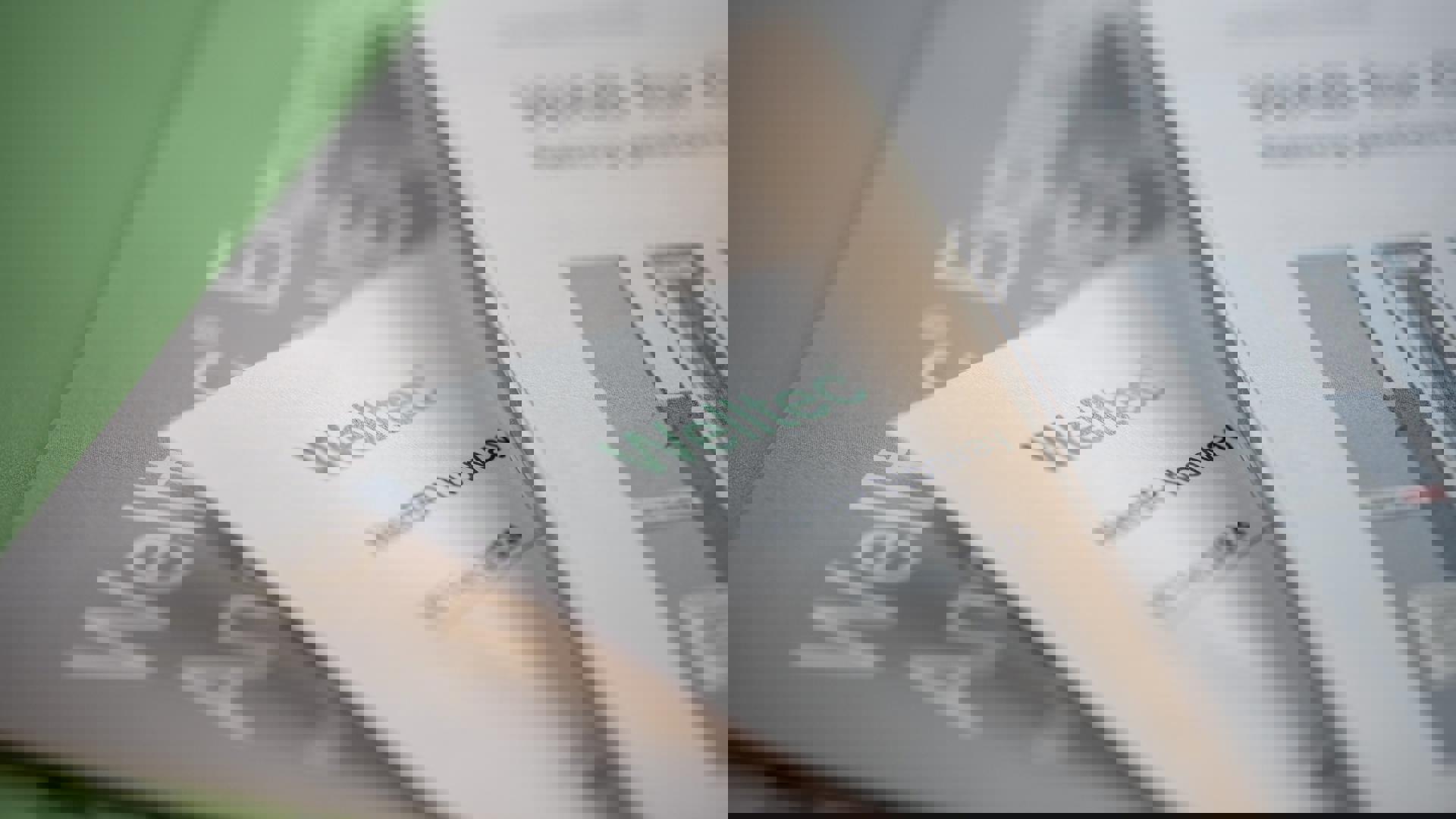 Close-up of Welltec brochures and documents, showcasing company branding and technical materials.