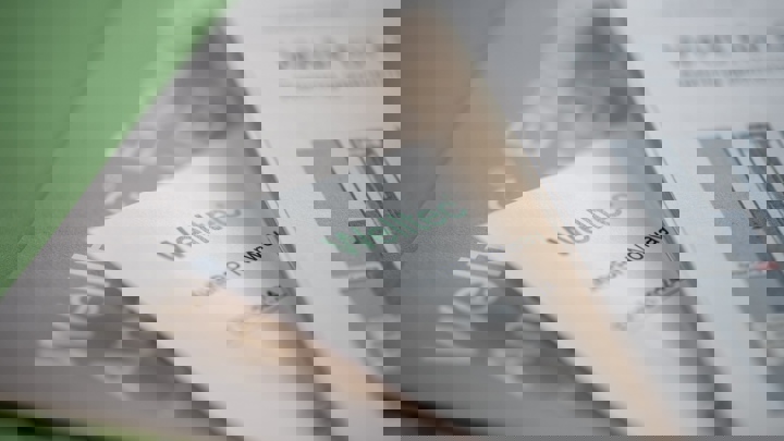 Close-up of Welltec brochures and documents, showcasing company branding and technical materials.