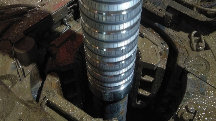 Welltec completion tool being lowered into the wellbore through the rotary table on a rig floor during deployment.