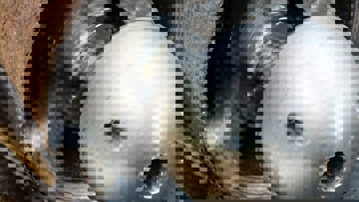 Close-up of a Well Cutter tool in action inside a metal pipe, showing spinning blades creating a clean and precise cut.