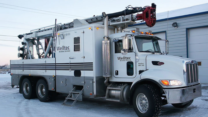 Welltec service truck equipped for SAGD operations, parked in a snowy environment.