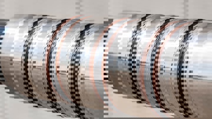 Close-up of Welltec Light Packer (WLP) showing polished metal body and zonal isolation elements.