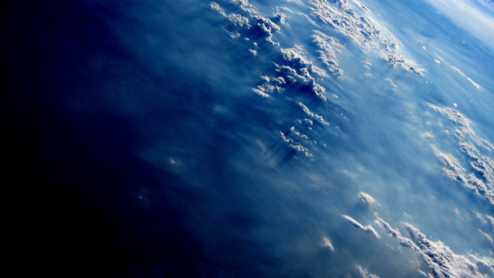 Satellite view of Earth's atmosphere and clouds, representing offshore data acquisition using Well Tractor for high-precision logging in Malaysian wells