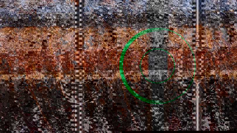 Cross-section of subsurface rock layers showing a Welltec tool deployed in the wellbore, highlighted with green rings for zone isolation.