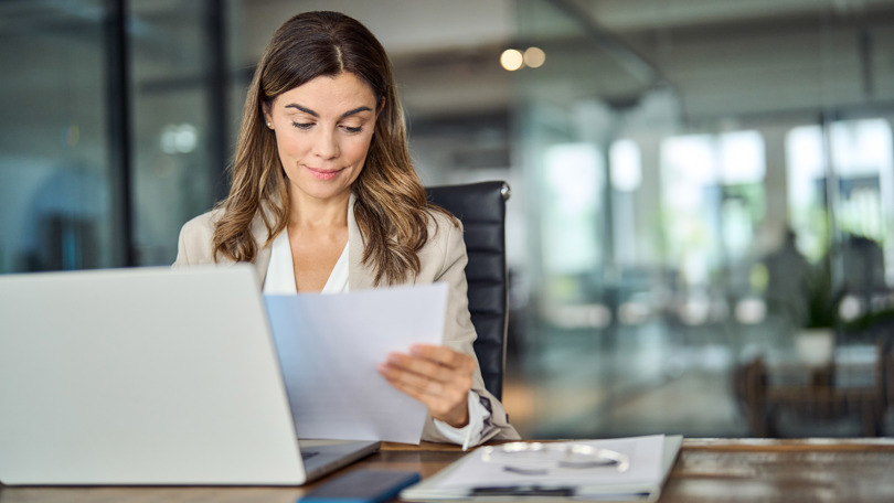 Woman sitting at a desk with a computer in front of her