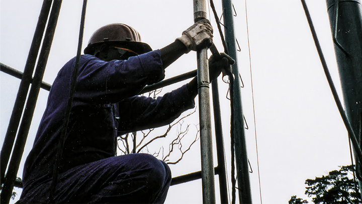 Worker in safety gear operates equipment on a rig during the first logging-while-tractoring PLT job in Kazakhstan.