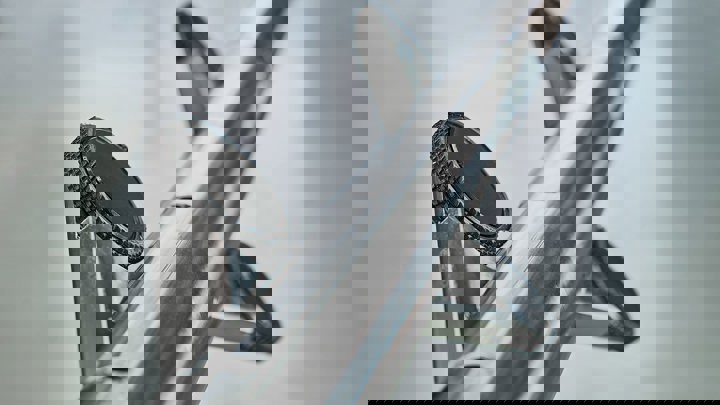 Close up of a Welltec tractor tool, highlighting its metal surface with circular components designed for downhole operations.