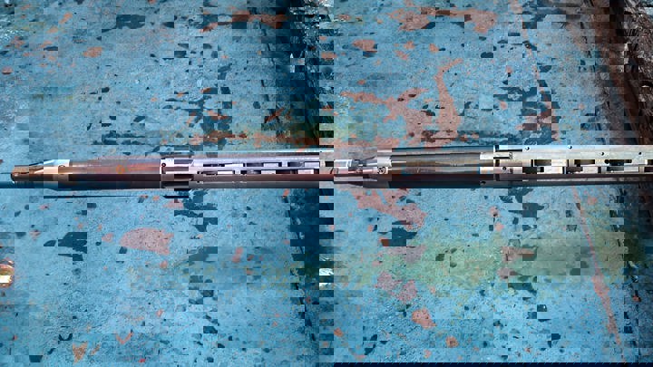 Welltec tool used for cleaning and setting a straddle during a 2015 well intervention, shown on a weathered blue surface before deployment.