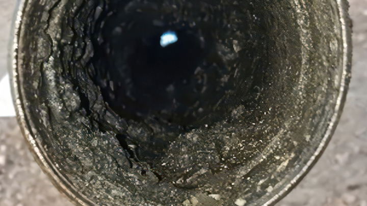 Interior view of milled glass plug showing rough surface texture after removal in a high-pressure condensate well.