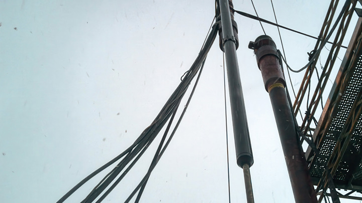 Toolstring suspended on rig floor during operation to set a failed production packer, as part of a well intervention procedure.