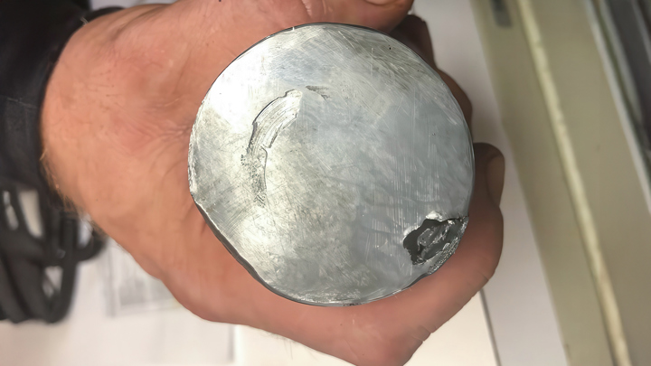 Close-up of a milled slickline fish retrieved during a job to restore well access and resume production operations.