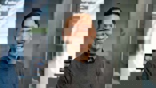 Chum Wai Hoe, Vice President of WCS Sales, smiling in front of a modern Welltec display with a professional appearance