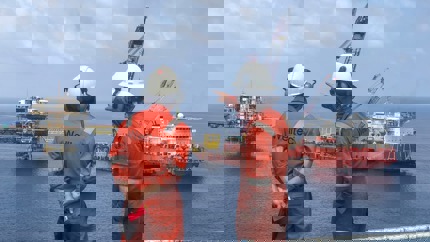 A digital illustration showing an offshore oil rig with a Welltec solution in the subsea environment, highlighted by a green circle.