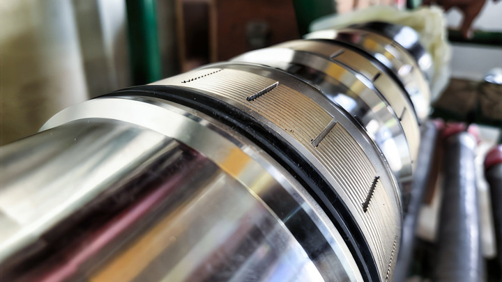 Close-up of a Welltec completion tool showing slotted metal sections and seals used for controlled zonal isolation.