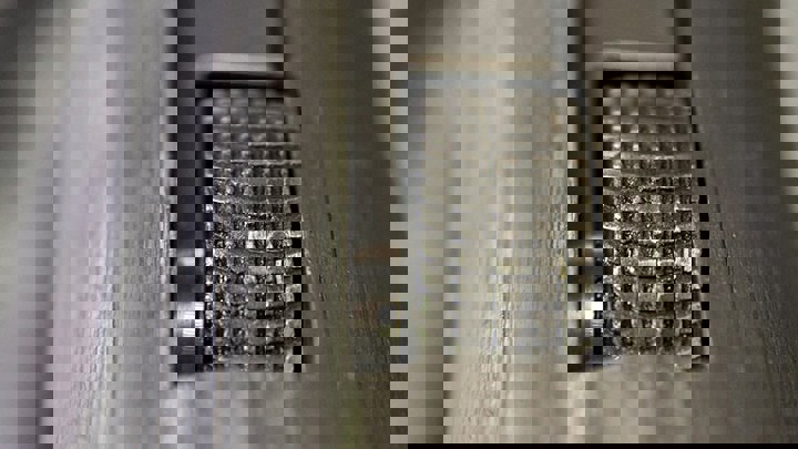 Close-up of a textured metal wheel inside a downhole tool used in well intervention operations.