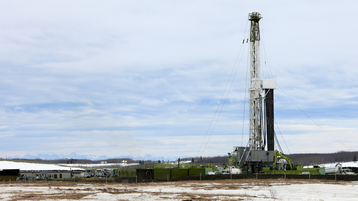 Onshore drilling rig operating on Alaska's North Slope during a Well Miller (CVF) intervention in snowy conditions.