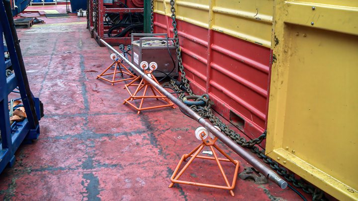 Wireline toolstring set up on rig floor for milling scale and setting a bridge plug on E-line