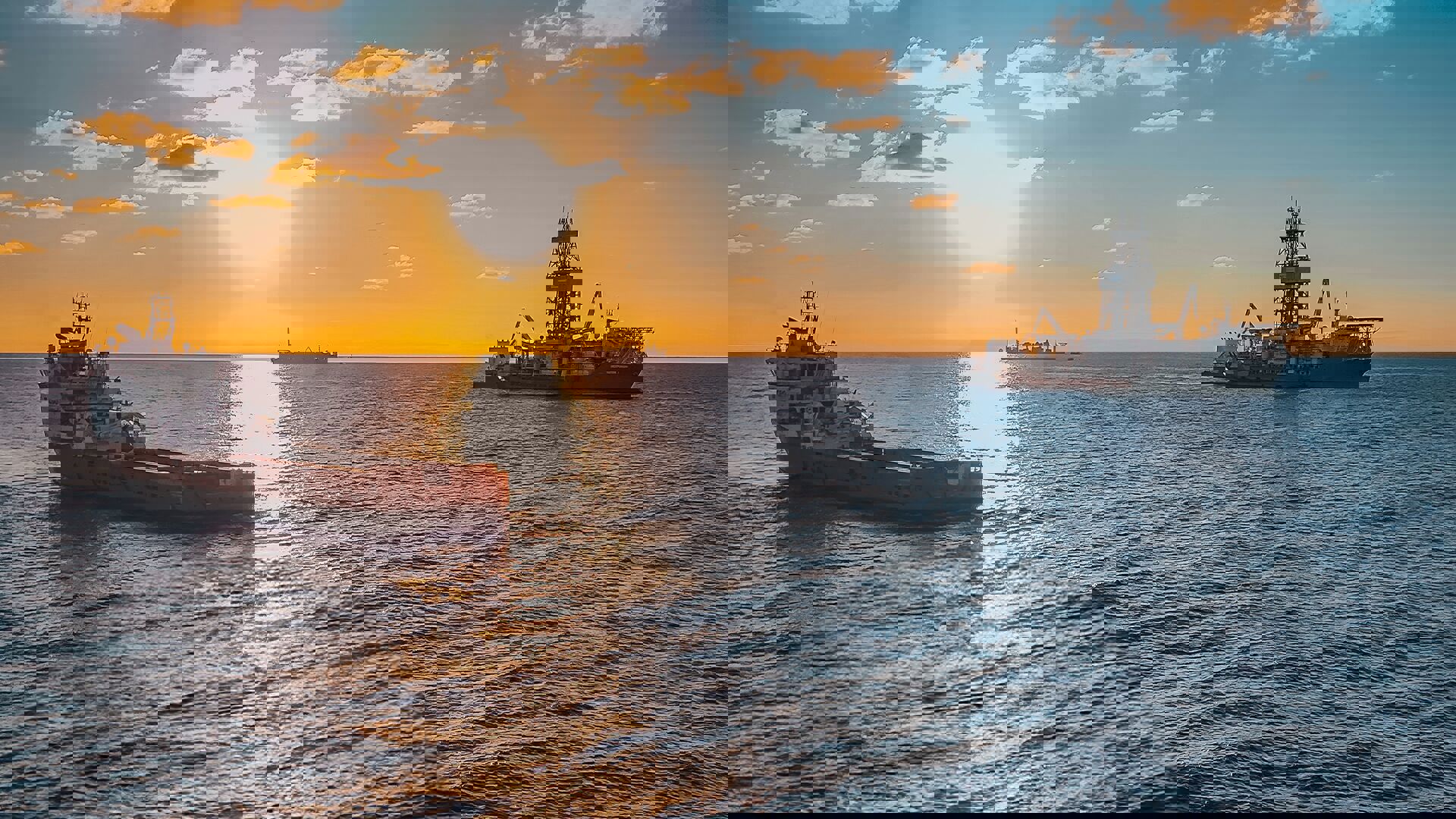 Sunset view of oil rigs in the ocean, with warm colors illuminating the sky and water around them.
